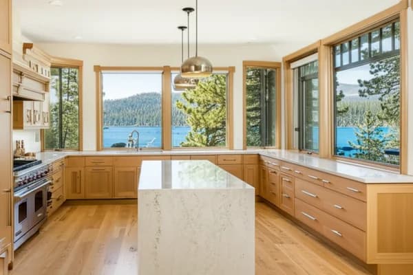 Design concept for a lake-view kitchen with pale oak cabinetry, a stone island, and windows turned toward the water, a direction suited to Dollar Point lakefront homes